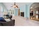 Bright sun room features tile floors, fireplace, ceiling fans, and view to the rest of the home at 2517 N Hightower Trl, Conyers, GA 30012