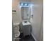 Compact bathroom design featuring a modern vanity, mirror, and well-lit space at 624 S Grand Nw Ave, Atlanta, GA 30318