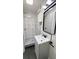 Modern bathroom featuring a walk-in shower with stylish tile and black hardware accents at 624 S Grand Nw Ave, Atlanta, GA 30318
