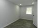 Bedroom with gray walls, wood look floors, window and door at 624 S Grand Nw Ave, Atlanta, GA 30318