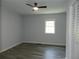 Bright bedroom with ceiling fan, wood look floors, gray walls and closet at 624 S Grand Nw Ave, Atlanta, GA 30318