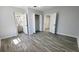A bedroom with gray walls, gray wood-look floors, closet, and door to bathroom at 624 S Grand Nw Ave, Atlanta, GA 30318
