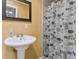Bright bathroom features a pedestal sink and cactus-themed shower curtain, creating a fresh and inviting space at 660 Simmons St, Atlanta, GA 30318