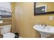 Functional bathroom with a pedestal sink, toilet, and storage rack, designed for convenience and practicality at 660 Simmons St, Atlanta, GA 30318