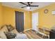 Bright bedroom with a ceiling fan, wood flooring, and a comfortable seating area, all bathed in natural light at 660 Simmons St, Atlanta, GA 30318