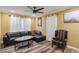 A cozy living room features new hardwood style floors, a comfortable leather couch, and a ceiling fan at 660 Simmons St, Atlanta, GA 30318