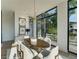 Dining room with large windows and stylish modern light fixture above the dining table at 816 Berne St # 3, Atlanta, GA 30316