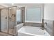 Bright bathroom featuring walk-in shower and separate soaking tub at 90 Citrine Way, Acworth, GA 30101
