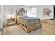 Neutral bedroom features a carved-wood bed frame and matching mirrored nightstand at 90 Citrine Way, Acworth, GA 30101