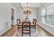Formal dining room featuring hardwood floors, a chandelier, and ample natural light from a large window at 90 Citrine Way, Acworth, GA 30101