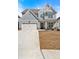Charming two-story home with blue siding, stone accents, an attached garage, and a well-manicured lawn at 90 Citrine Way, Acworth, GA 30101