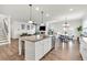 Open-concept kitchen with granite countertops and stainless steel appliances offers easy flow into living area at 90 Citrine Way, Acworth, GA 30101
