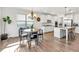 Open kitchen and dining area with stainless steel appliances, a center island, and hardwood flooring at 90 Citrine Way, Acworth, GA 30101