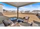 Covered patio offers seating and outdoor living overlooking the fenced backyard at 90 Citrine Way, Acworth, GA 30101