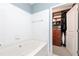 Bright bathroom with a white tiled wall next to a custom organized walk-in closet at 3040 Peachtree Nw Rd # 1509, Atlanta, GA 30305