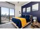 Bedroom featuring floor-to-ceiling windows and city skyline views from the private balcony at 3040 Peachtree Nw Rd # 1509, Atlanta, GA 30305