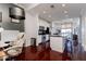 Bright, open-concept living space with hardwood floors, stainless steel appliances, and a breakfast bar at 3040 Peachtree Nw Rd # 1509, Atlanta, GA 30305
