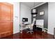 Office area with door, hardwood floors, built-in shelving, and modern lighting at 3040 Peachtree Nw Rd # 1509, Atlanta, GA 30305