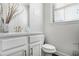 Bright bathroom featuring a white vanity with a stone countertop, and a matching toilet at 4327 Water Elm Aly, Doraville, GA 30360