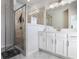 Bright bathroom featuring a glass shower, gray tile, double vanity and white cabinetry at 4327 Water Elm Aly, Doraville, GA 30360