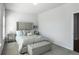 Cozy bedroom with tufted headboard, bench, carpeted floors, and bright light at 4327 Water Elm Aly, Doraville, GA 30360