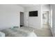 A bright bedroom with an ensuite bathroom and large television on the wall at 4327 Water Elm Aly, Doraville, GA 30360