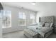 A bedroom featuring a bed with a tufted headboard and a bench at the foot of the bed at 4327 Water Elm Aly, Doraville, GA 30360