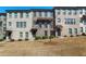 Modern townhome featuring a brick facade, covered entrances, and manicured landscaping at 4327 Water Elm Aly, Doraville, GA 30360