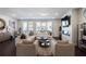 An open living room with dark wood flooring and a fireplace with white stone accenting at 4327 Water Elm Aly, Doraville, GA 30360