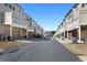 Row of new townhomes featuring garage parking, small balconies, and pristine landscaping at 4327 Water Elm Aly, Doraville, GA 30360