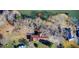 Aerial view of property on the water with a dock, outbuildings, and driveway at 5010 Highway 20 Ne, Conyers, GA 30012