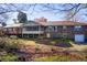 View of the house with a screened porch, deck, and two-car garage in the backyard at 5010 Highway 20 Ne, Conyers, GA 30012