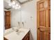 Well-lit bathroom vanity with a sink, large mirror, and a decorative light fixture at 5010 Highway 20 Ne, Conyers, GA 30012