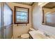 A bright bathroom offers a window and shower with glass doors at 5010 Highway 20 Ne, Conyers, GA 30012