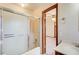 This bathroom features a shower with sliding doors, white sink, and tile flooring at 5010 Highway 20 Ne, Conyers, GA 30012
