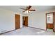 A large bedroom with neutral carpet features a closet and adjoining bathroom at 5010 Highway 20 Ne, Conyers, GA 30012