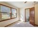 Sunlit bedroom features two windows with wood trim, offering a view of the outdoors at 5010 Highway 20 Ne, Conyers, GA 30012