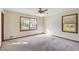 A large, carpeted room offers great natural light from its two large windows at 5010 Highway 20 Ne, Conyers, GA 30012