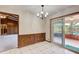 Cozy dining room with chandelier, tiled floors, and sliding door access at 5010 Highway 20 Ne, Conyers, GA 30012