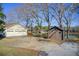 Driveway leading to a house, garage and wooden shed with picturesque view of the lake at 5010 Highway 20 Ne, Conyers, GA 30012