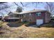 Brick house features a screened porch, deck, and a walkout basement with a convenient garage for added storage at 5010 Highway 20 Ne, Conyers, GA 30012