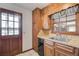 Cozy kitchen area with wood cabinets, a window, and a view of the outdoors at 5010 Highway 20 Ne, Conyers, GA 30012