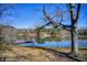Scenic lake view with a red dock extending into the water, surrounded by bare trees under a clear sky at 5010 Highway 20 Ne, Conyers, GA 30012