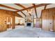 Inviting living room features a stone fireplace and vaulted beamed ceilings at 5010 Highway 20 Ne, Conyers, GA 30012