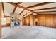 Spacious living room with wood paneling, a stone fireplace, and vaulted ceilings at 5010 Highway 20 Ne, Conyers, GA 30012