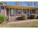 Welcoming brick porch with elegant railing and lush landscaping at 5010 Highway 20 Ne, Conyers, GA 30012