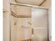 Bathroom shower enclosure with a sliding door, safety bars, and tiled walls at 5010 Highway 20 Ne, Conyers, GA 30012