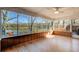 Bright sunroom with hardwood flooring and panoramic lake views at 5010 Highway 20 Ne, Conyers, GA 30012