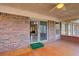 Enclosed sunroom with brick exterior and a view into the dining room at 5010 Highway 20 Ne, Conyers, GA 30012