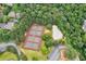 Aerial view showcases tennis courts, a freeform pool, and mature trees within a residential community at 5053 Chapel Xing, Douglasville, GA 30135